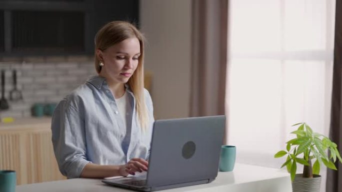 在远程工作场所使用笔记本电脑的女商人。女人在家使用笔记本电脑。