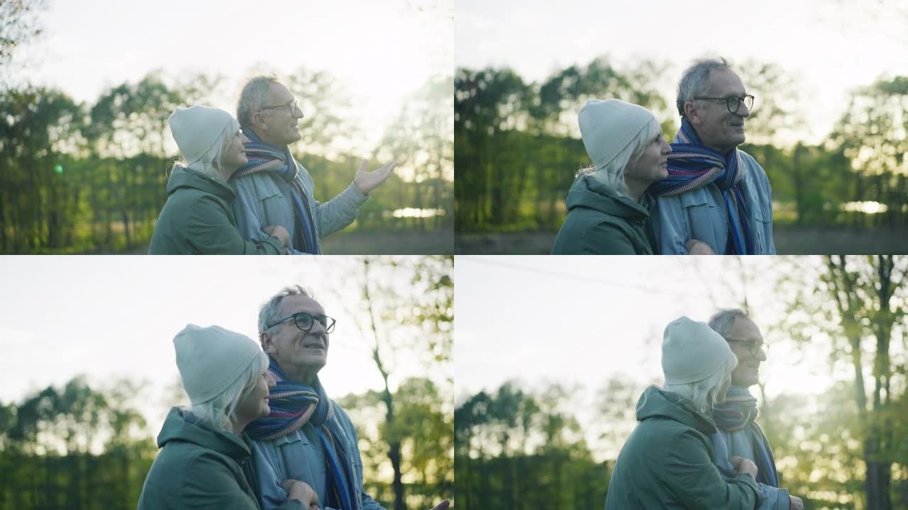 相爱的老年夫妇走在公园里互相拥抱