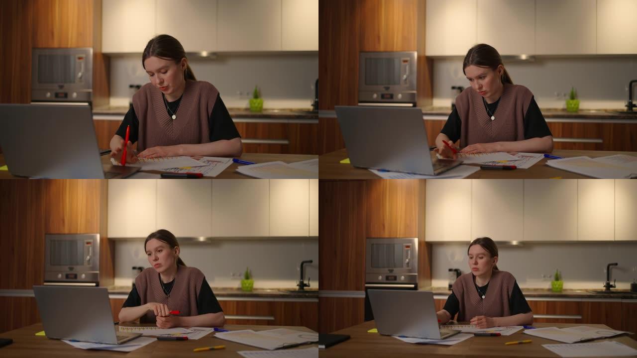 一个沉思的女人看着文件，桌子上的图表在纸上做笔记。一个疲惫的女人在家工作。远程学习分析与规划