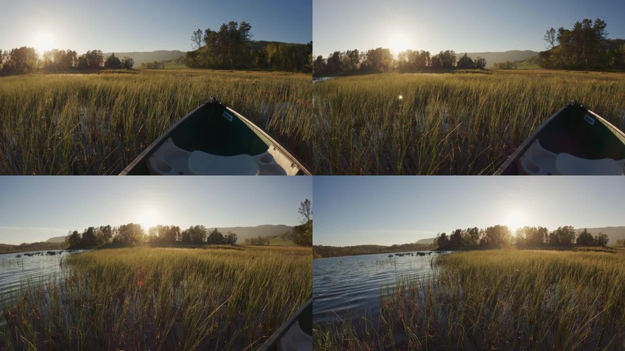 户外冒险: 日落时在湖中划独木舟