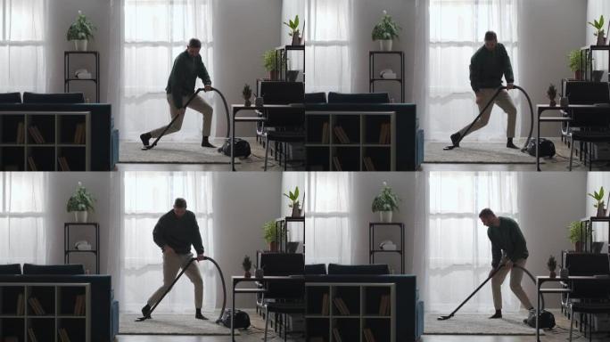 有趣的家伙在公寓里和吸尘器跳舞，在家打扫卫生，在现代室内玩得开心