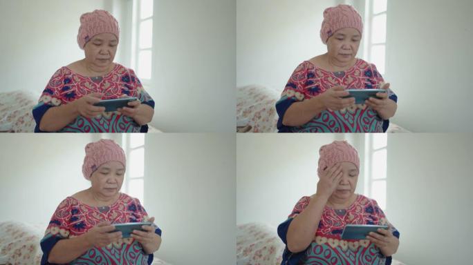 使用智能手机拍摄的亚洲癌症高级女性肖像