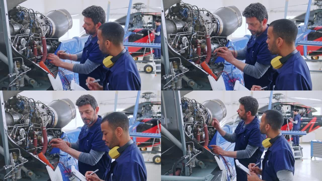 DS高级航空机械师在直升机发动机上工作时教他的男学徒