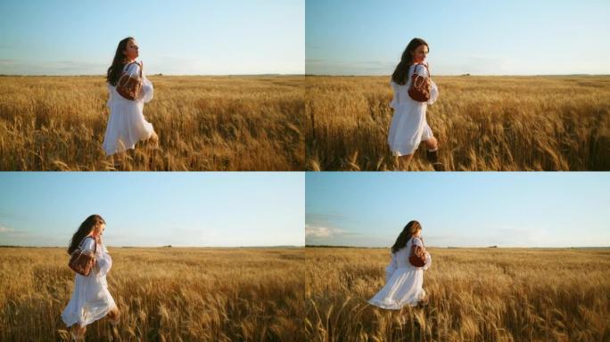 夏日无忧无虑的年轻女子正走在金色的麦田里，浪漫的乡村风格拍摄