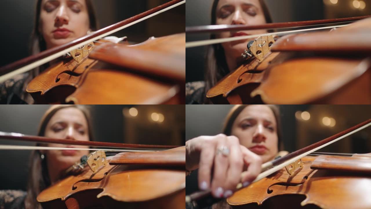 才华横溢的女小提琴手在音乐厅现场拉小提琴，手中的小提琴特写