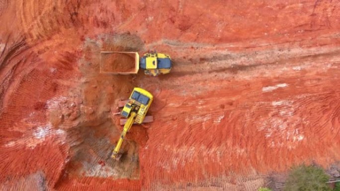 挖掘机用于通过用挖掘机倾倒土来准备将地面装载到建筑工地上的自卸车中