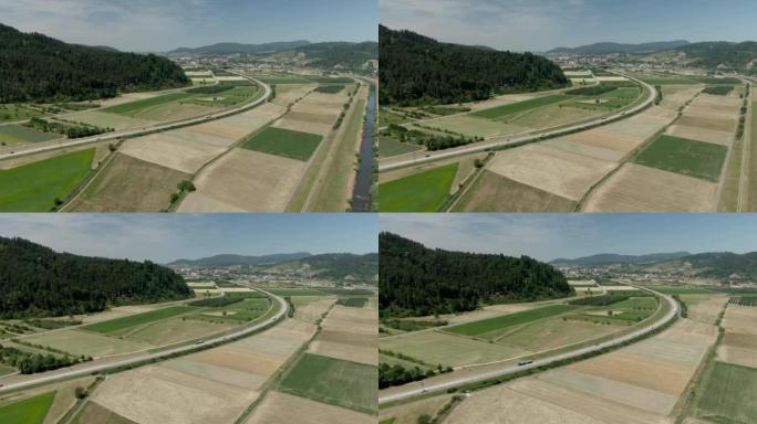空中无人机拍摄了穿过农田的高速公路