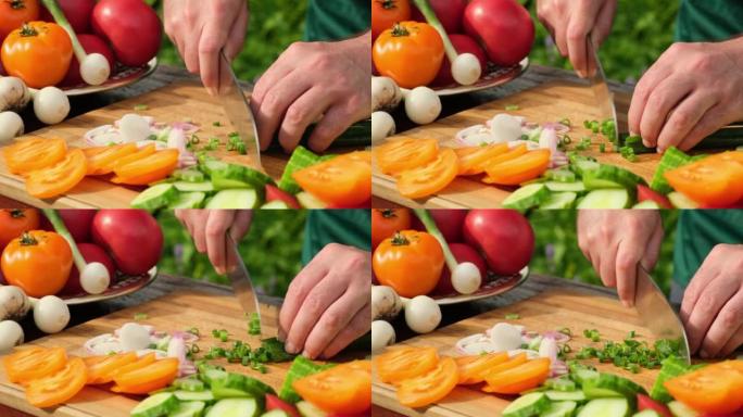 在户外做蔬菜沙拉。库克切西红柿，黄瓜，蔬菜，洋葱，橄榄油的沙拉。健康膳食和营养概念。用刀用新鲜生蔬菜
