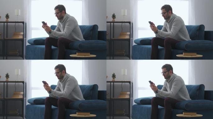 聪明的人正在通过智能手机阅读互联网新闻，独自坐在家里，上网和社交网络