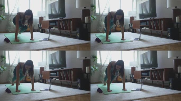 年轻女子在公寓客厅做瑜伽