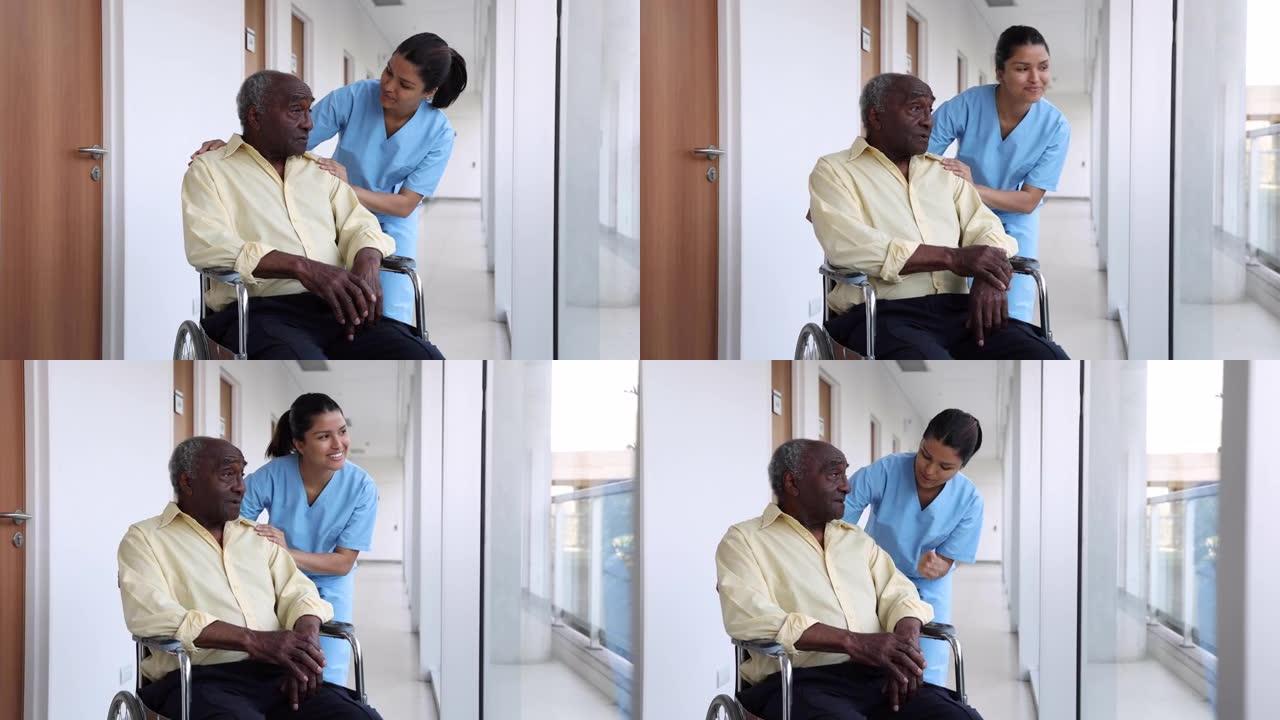 开朗的护士试图在辅助生活设施的轮椅上安慰黑人高级患者
