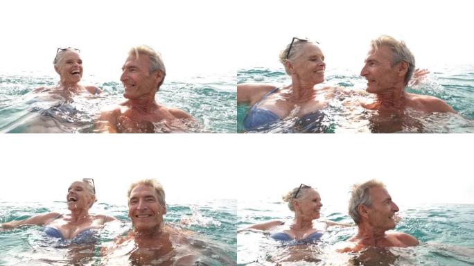 夫妇在温和的冲浪中享受海边时光