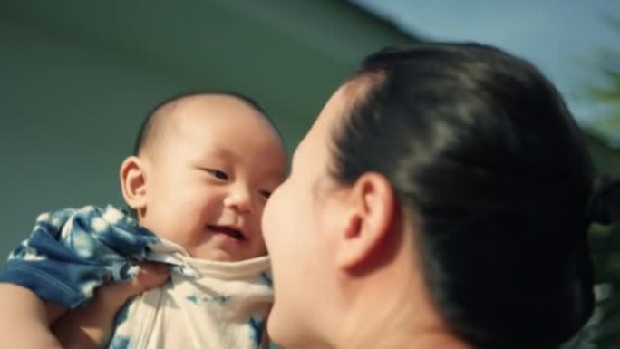 微笑的男婴在和妈妈玩耍时享受。