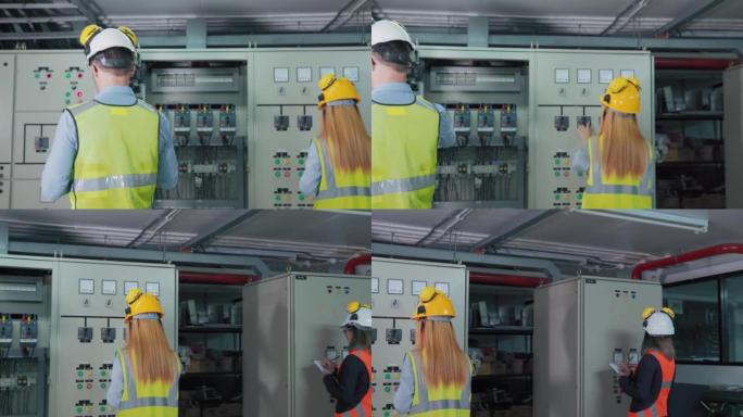 团队电气工程师技术员检查控制室的电气控制板