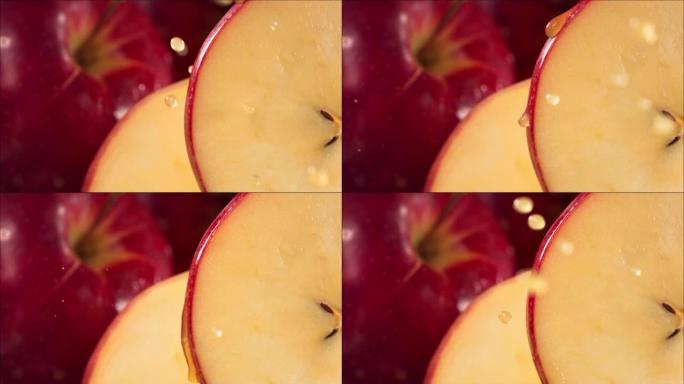 一滴果汁从成熟多汁的红苹果片的表面流下。慢动作4K