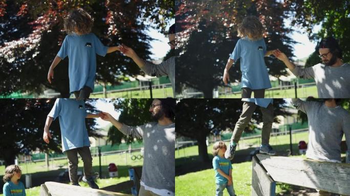 父亲帮助儿子 (小男孩) 在平衡木上行走