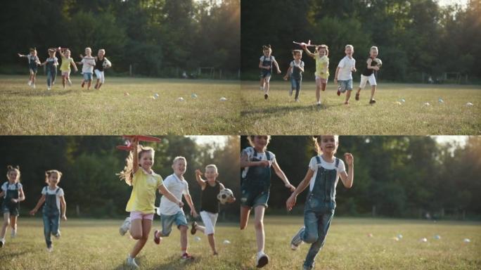 一群快乐的孩子，在阳光明媚的白天在田野里用飞机和足球奔跑