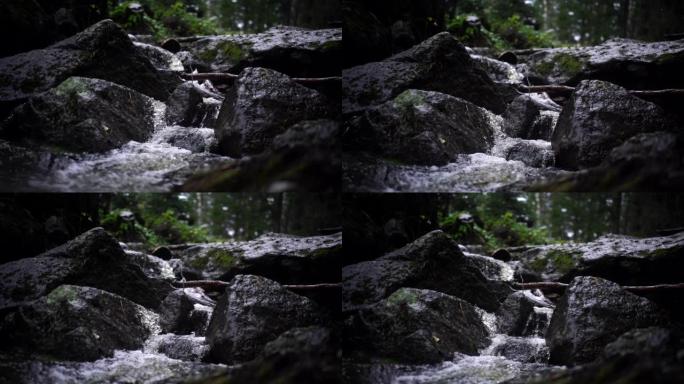 近距离拍摄阿斯特雷姆 (astream) 的黑暗场景，山上有河石和树木