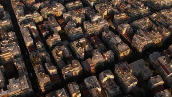 无人机鸟瞰图在日落时飞越雅典的城市场景