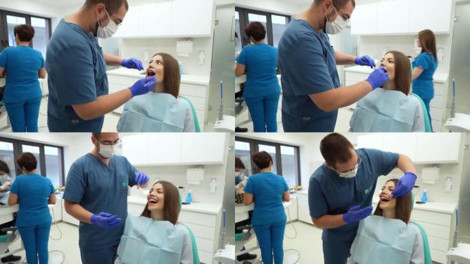 对女性患者进行口腔检查的高加索男性牙医