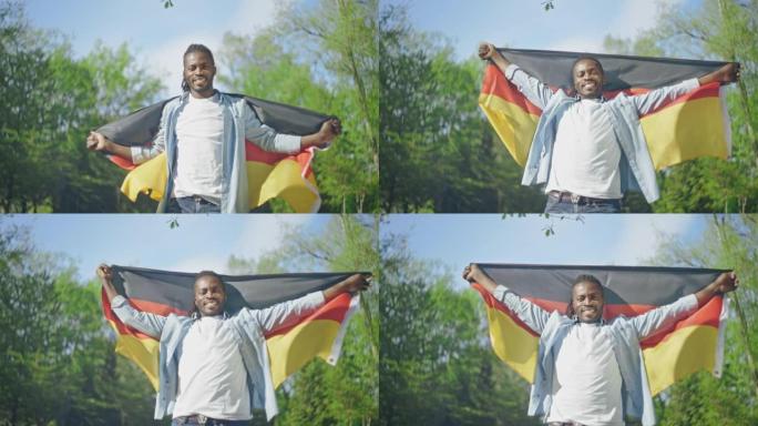 年轻的黑人男子在公园里挥舞着三色旗，热血沸腾