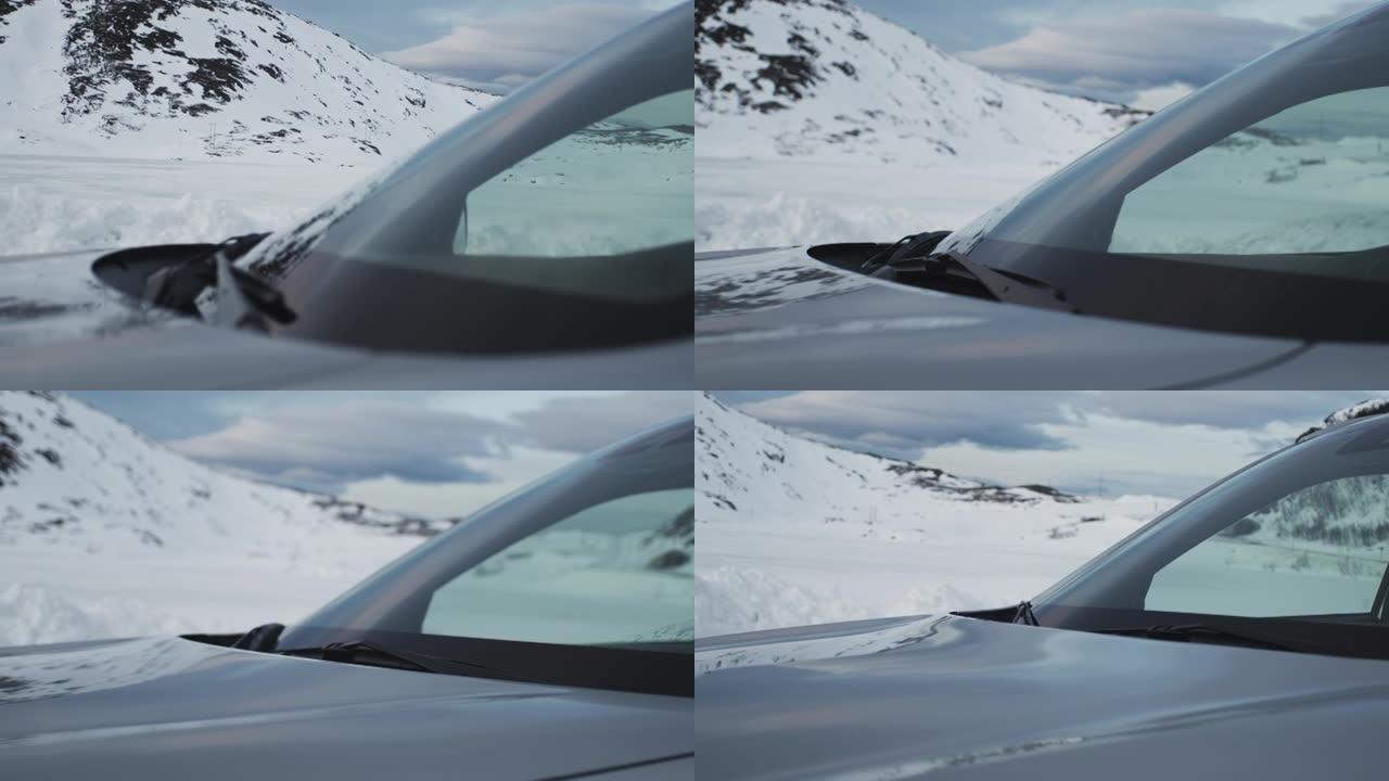 透过车窗看。积雪覆盖的山脉和杂草