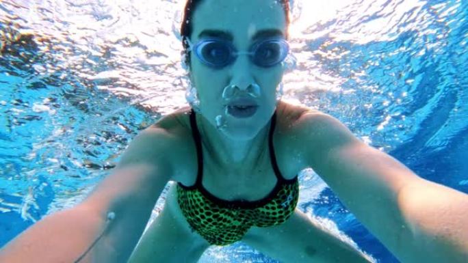 可穿戴相机视点，女子在游泳池潜水