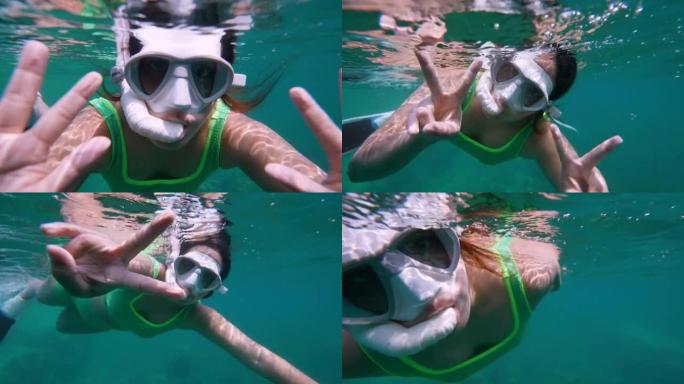 带潜水面具的年轻女子的水下肖像