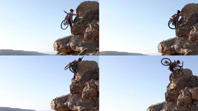 女山地车手将自行车骑上陡峭的岩石顶峰