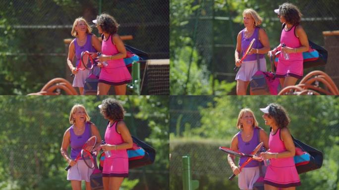 SLO MO TS两名中年妇女在网球练习后笑着说话