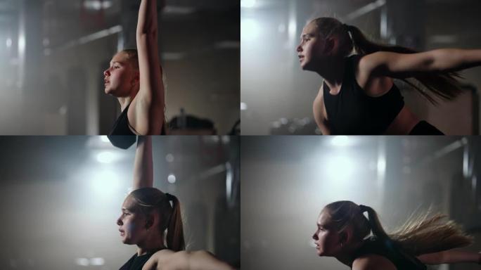 金发女子在健身房训练，举起哑铃，慢动作射击，在健身中心努力工作