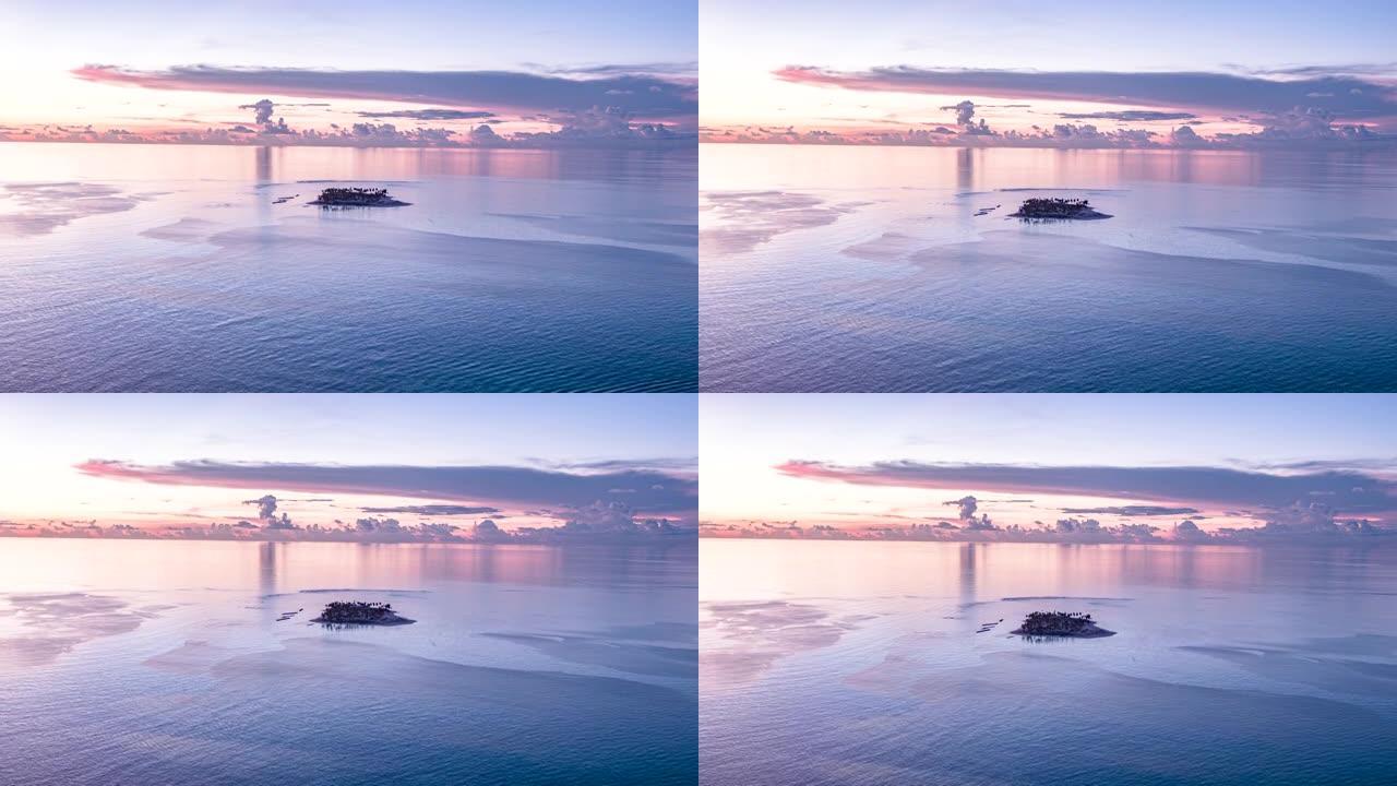 空中无人机拍摄日落时被海洋包围的小岛