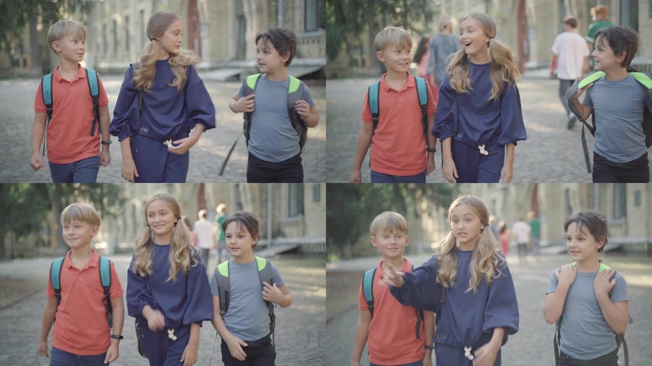 可爱兴奋的小女孩和同学散步，高中生路过时说话的肖像。无忧无虑的孩子喜欢学习。多代教育的概念。