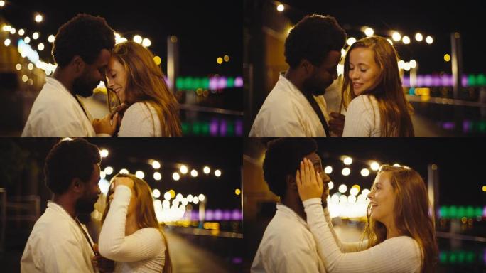 跳舞和爱。年轻多样的夫妇在潮湿的城市街道上表演性感舞蹈。夜晚的浪漫场景。特写镜头。