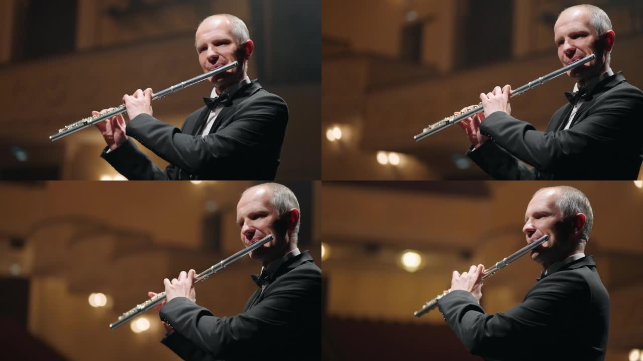 男人在音乐厅演奏长笛，交响乐团或铜管乐队的音乐家，经典音乐音乐会
