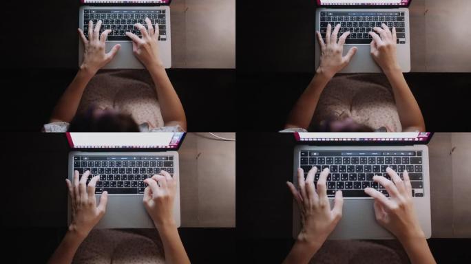 新常态: 女性的手在晚上在笔记本电脑上打字。