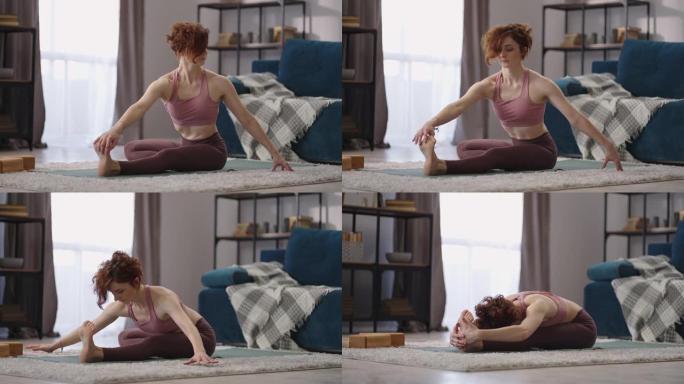 在家对成年女性进行伸展训练，女运动员坐在地板上，进行柔韧性锻炼