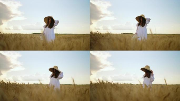 夏日平静美丽的女人独自走在金色的麦田上，美女的肖像