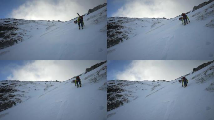 一队登山者在山顶上移动。冬季冒险