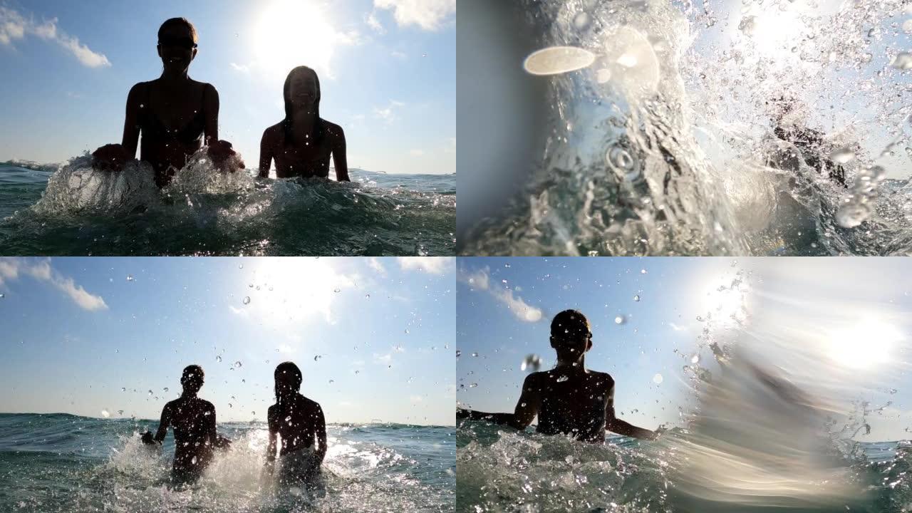 女性朋友在海里泼水玩得开心。剪影