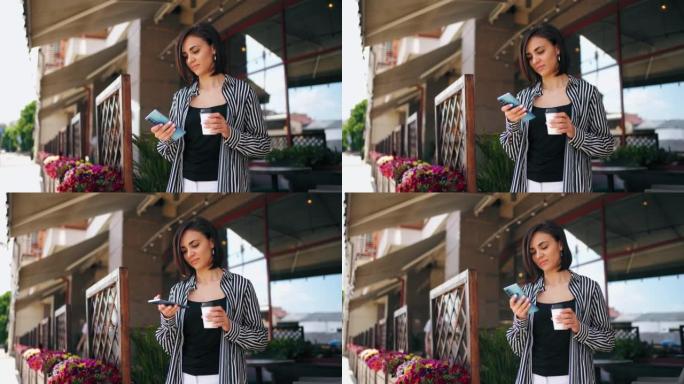 美女在智能手机中使用应用程序，拿着杯子和咖啡，肖像