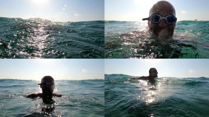 夏天在海里浮潜。男子游泳和跳入水中。戴游泳眼镜