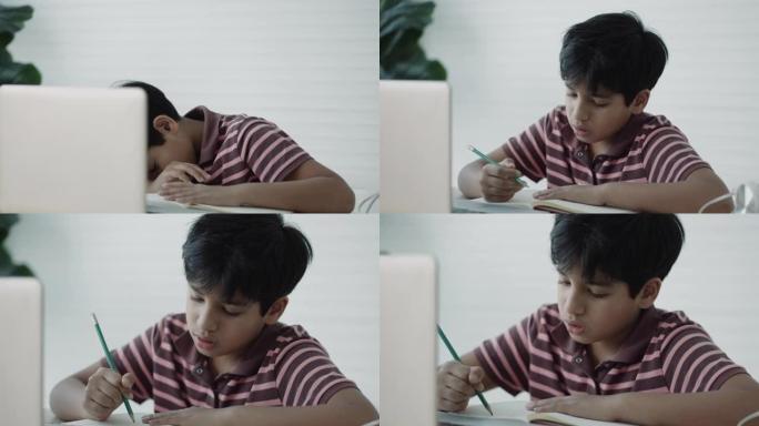 亚洲男孩在家中使用笔记本电脑进行在线学习
