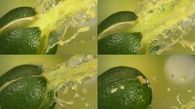 绿色自然背景下慢动作的新鲜酸橙水果喷汁4K