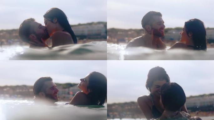 浪漫的异性恋夫妇一起在海里游泳。拥抱和亲吻