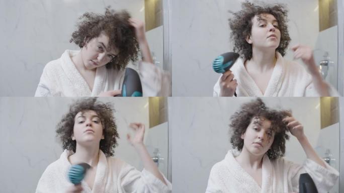 酒店浴室用吹风机给头发定型头发的卷发女人，美容程序