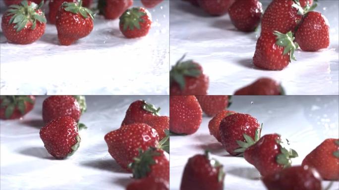 草莓在白色背景上滚动。慢动作