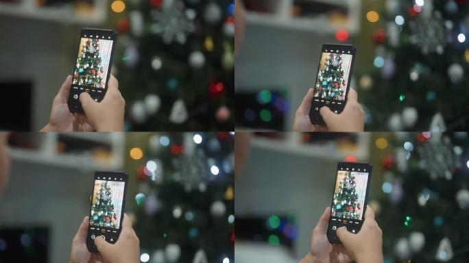CU: 女人的手在家里拍圣诞树的照片