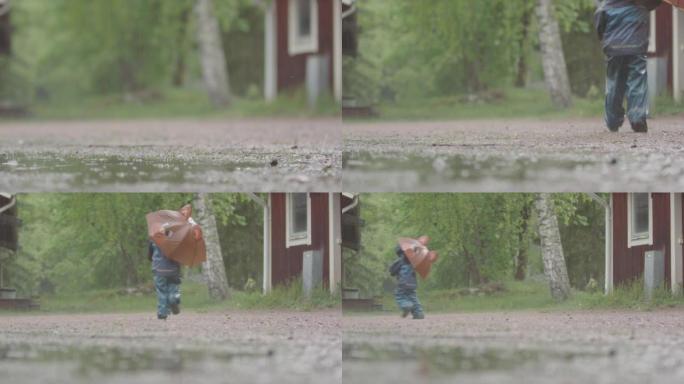 极端天气-一个带伞的孩子在大雨中奔跑