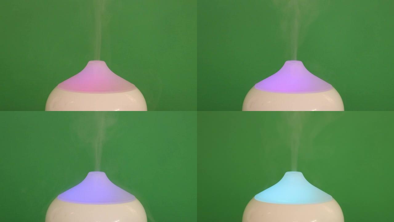一个白色香薰油扩散器加湿器的特写，它呼出芳香雾，带有变色灯